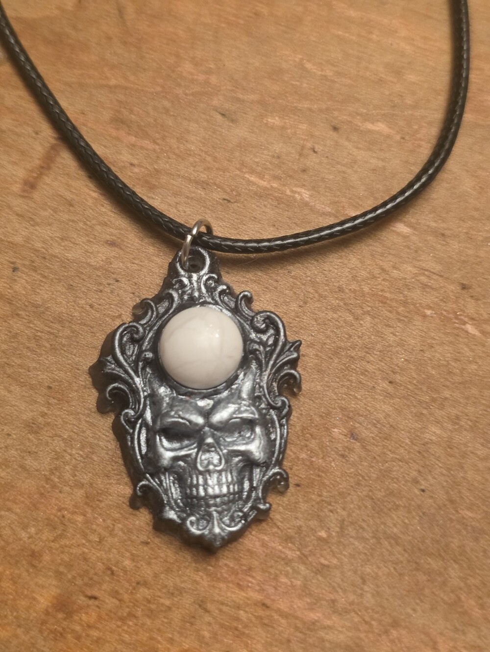Silver Gothic Resin Skull With White Central Gemstone On Blacl Cord Necklace